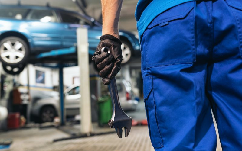 Professional Mechanic Repairing Car Engine.